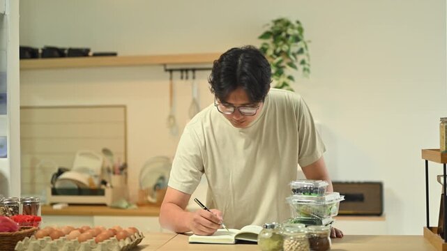 Man Checking Nutrition Label on Packaged Bread in Kitchen
