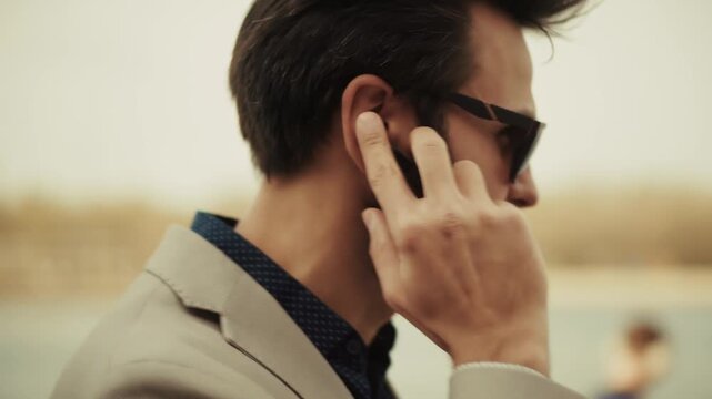 Businessman Adjusting Wireless Earbud While Looking Away