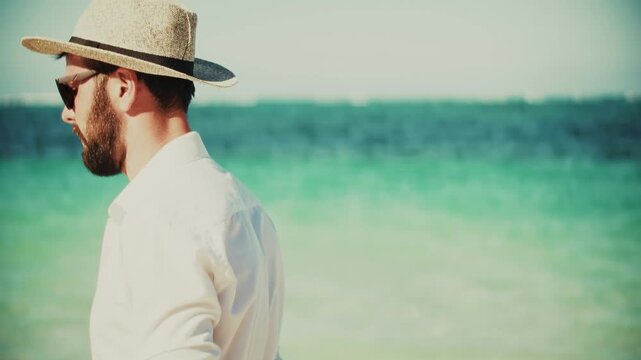 Traveler Wearing Straw Hat Looking At Turquoise Sea During Summer Vacation By The Ocean