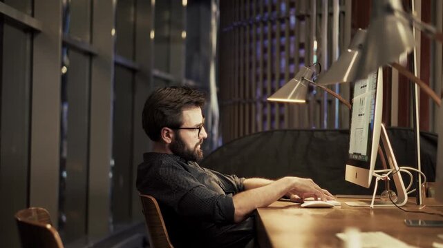 Office Worker Sitting At Desk With Computer Feeling Tired And Stressed During Late Night Shift
