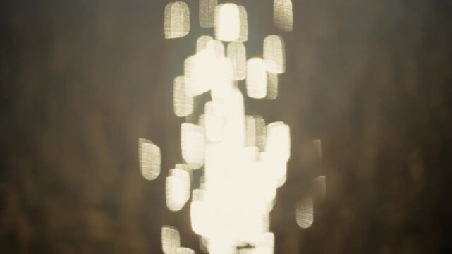 Abstract Blurred Bright Bokeh Lights Shining Through Dark Background Creating Soft Glow Effect