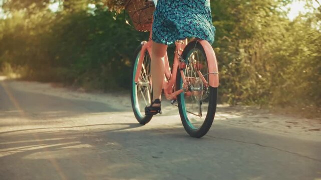 Woman Riding Bicycle With Wicker Basket Along Sunlit Country Road Summer Day