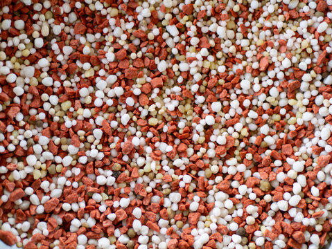 Close up of mixed chemical fertilizer granules (15-5-25) for agriculture background 
