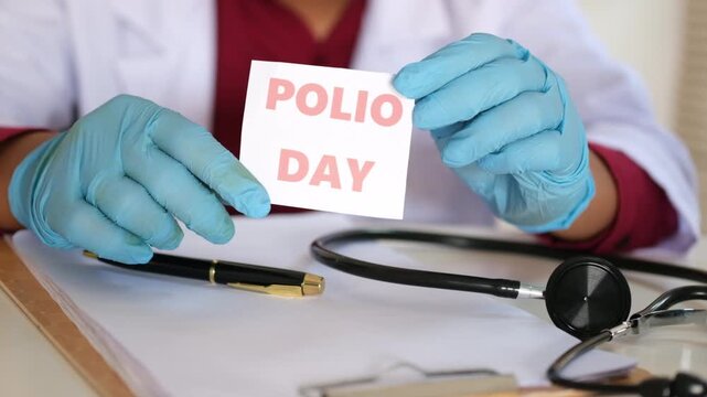 A doctor holding a sign reading "POLIO DAY." World Polio Day observance. Polio prevention and treatment.