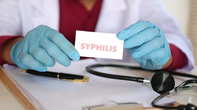 A doctor holding a sign reading "Syphilis." Concept of sexually transmitted diseases. Prevention and treatment.