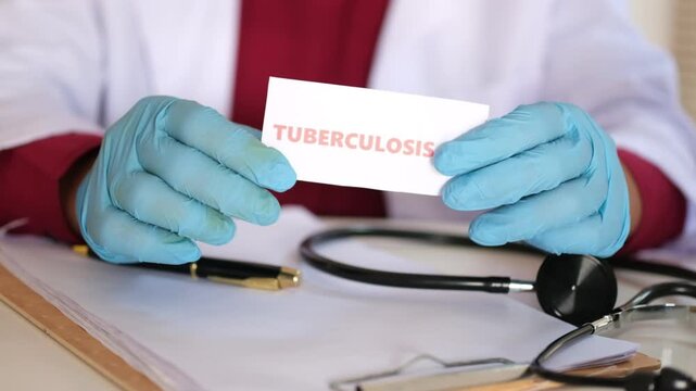 A doctor holding a sign reading "Tuberculosis." Infectious disease. Prevention and treatment of infectious diseases.