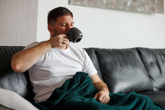 Man drinking coffee while relaxing at home