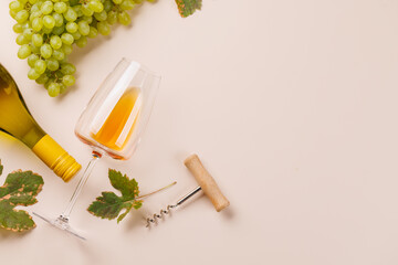 Naklejka premium White wine bottle corkscrew and vine leaves - flat lay