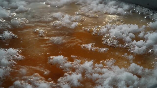 Hot Brine Crystallizing into Salt in Industrial Evaporation Pan
