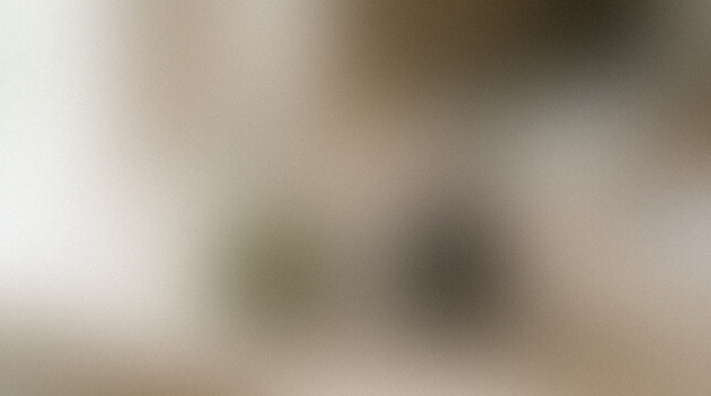 Blurred indistinct shape with a neutral beige background creates a soft out of focus visual abstract ambiguous blurry defocused diffuse formless gradient