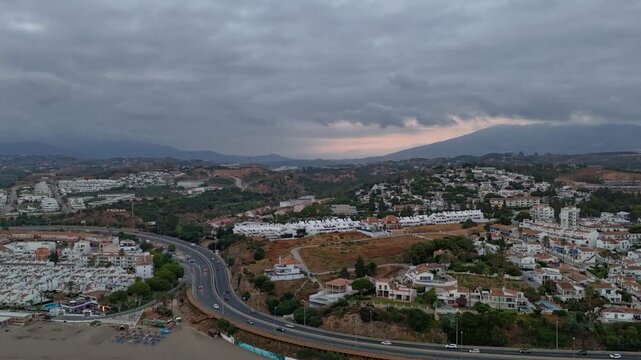 Hyperlapse Aerial View of La Cala de Mijas at Dusk with Dramatic Clouds and Sunset Light, Costa del Sol, Malaga, Spain