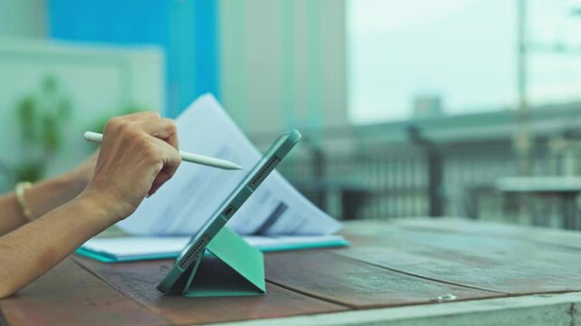 Freelancer conducting business analysis outdoors, managing business workflow alongside financial calculation as business planning meets digital design.