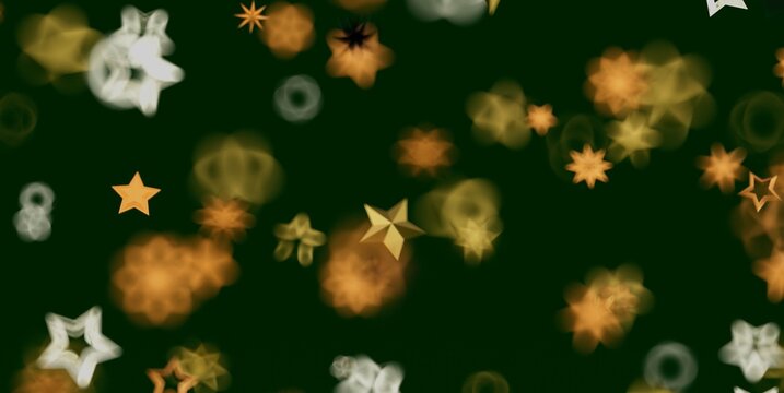 Shimmering golden star bokeh lights create a festive and magical abstract background.