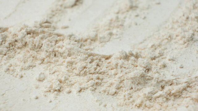 Rotating organic spelt wheat flour powder texture top view