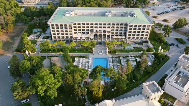 Astor Garden hotel building swimming pool aerial drone sunrise view Saints Constantine and Helena Varna Bulgaria stock footage