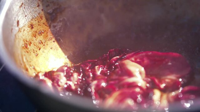 Hibiscus flowers simmer in a pot for a delicious floral infusion