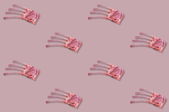 Raw racks of lamb with exposed rib bones repeated in spaced rows across a muted pink culinary pattern background