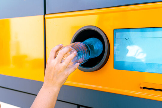 Plastic bottle inserted into reverse vending machine.