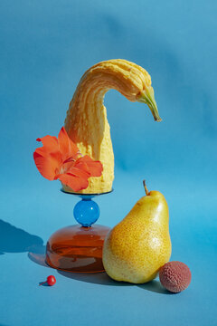 Creative display of fruits and vegetables on blue background