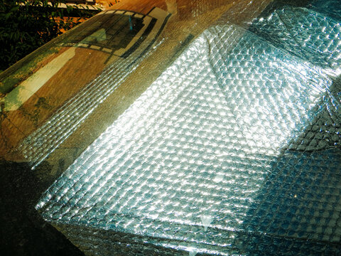 Reflective Windshield Sun Shades in Parked Car