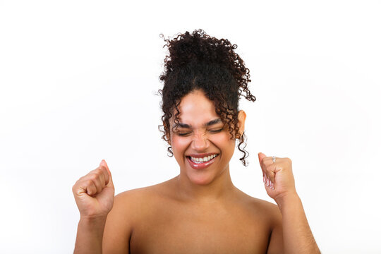 Woman celebrating skincare success with a joyful expression isolated on a white background