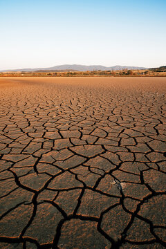 Climate change consequences with dried lake at sunset