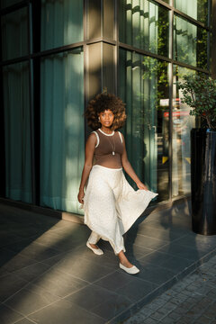 A woman walks in a modern area of the city