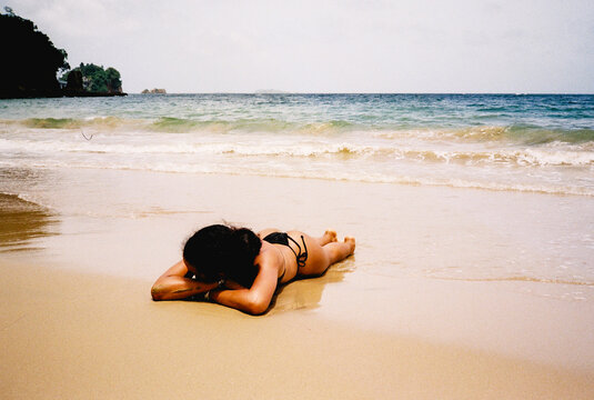 Woman relaxing on Caribbean beach shoreline