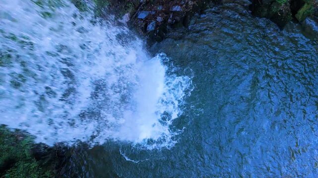 Aerial drone view of a winter landscape and waterfall near Selaya in the Pasiegos Valleys, Cantabria, Spain, Europe