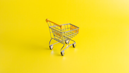 Rear view of yellow miniature shopping cart on yellow background. Concept for retail ecommerce online shopping and consumerism.  © wibiwisnu