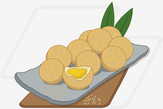 onde onde Delicious Golden Fried Sesame Balls Served on a Decorative Rectangular Tray with Fresh Green Leaves