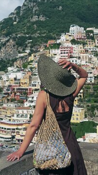 Stylish Woman Enjoys Panoramic View of Positano Amalfi Coast Italy