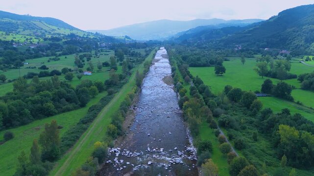 Aerial view from a drone of the Pas River in Corvera de Toranzo. Pas Valley in the Pasiegos Valleys region. Cantabria. Spain. Europe