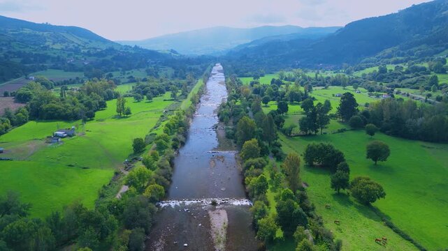 Aerial view from a drone of the Pas River in Corvera de Toranzo. Pas Valley in the Pasiegos Valleys region. Cantabria. Spain. Europe