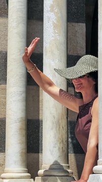 Woman Waving in Front of Historic Amalfi Cathedral Italy