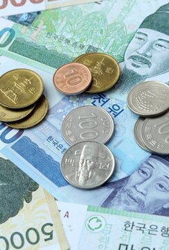 South Korean won money banknotes and coins on table. South Korea cash bills of KRW currency