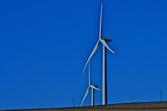 Two giant turbines and old telephone poles dot hillside, Altamont Pass, Alameda County, California 