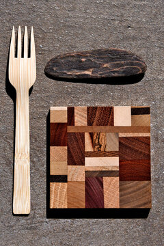 Wood vignette. Driftwood, A Coaster made of different types of wood and a wooden fork