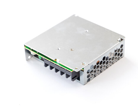 Metal encased switching power supply unit on white background