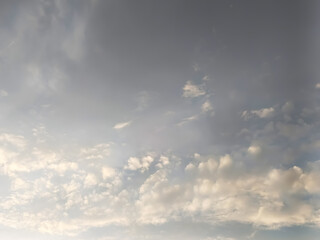 Wispy clouds drift across a serene sky during daylight with soft overhead light creating atmosphere © Md