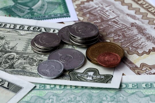 Cuban peso money notes and coins on table. Cuba cash bills of CUP currency close up