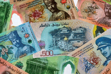 Big amount of Brunei dollar money banknotes. Brunei cash bills of BND currency close up © Marharyta
