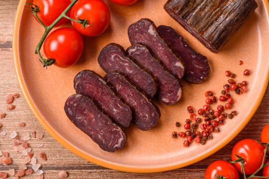 Sliced dry cured beef sausage or basturma with salt and spices. Sliced basturma