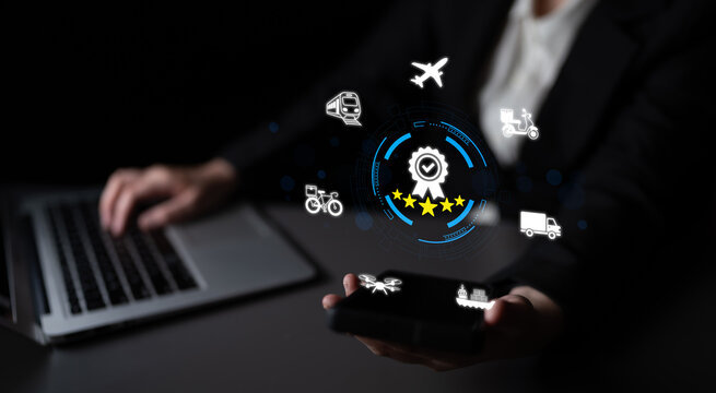 Business professional interacts with smartphone and laptop, exploring digital icons that represent innovative logistics and transportation solutions in a modern workspace. Nascent