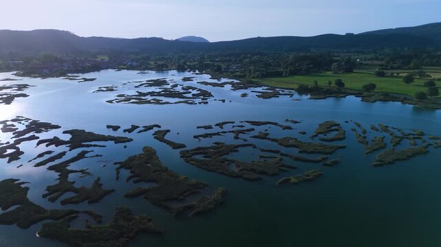 Aerial drone view of the marshes at low tide at sunset in Escalante in the Marismas de Santo&ntilde;a, Victoria y Joyel Natural Park. Cantabrian Sea. Santo&ntilde;a, Cantabria, Spain, Europe