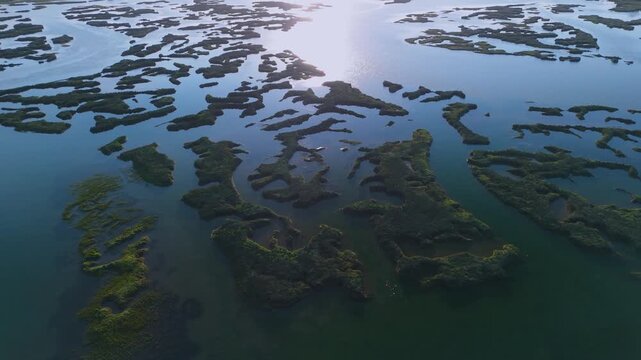 Aerial drone view of the marshes at low tide at sunset in Escalante in the Marismas de Santo&ntilde;a, Victoria y Joyel Natural Park. Cantabrian Sea. Santo&ntilde;a, Cantabria, Spain, Europe