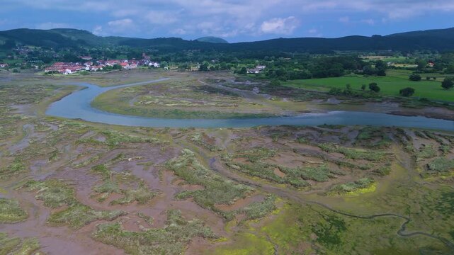 Aerial drone view of the marshes at low tide in Escalante in the Marismas de Santo&ntilde;a, Victoria y Joyel Natural Park. Cantabrian Sea. Santo&ntilde;a, Cantabria, Spain, Europe