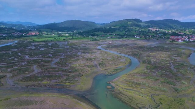Aerial drone view of the marshes at low tide in Escalante in the Marismas de Santo&ntilde;a, Victoria y Joyel Natural Park. Cantabrian Sea. Santo&ntilde;a, Cantabria, Spain, Europe