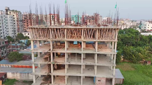 Buildings rise from the ground during construction in a densely populated city cityscape