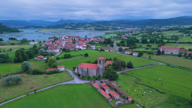Church of Santa Cruz and town of Escalante seen from a drone in the Parque Natural de las Marismas de Santo&ntilde;a, Victoria y Joyel Natural Park. Cantabrian Sea. Escalante, Cantabria, Spain, Europe